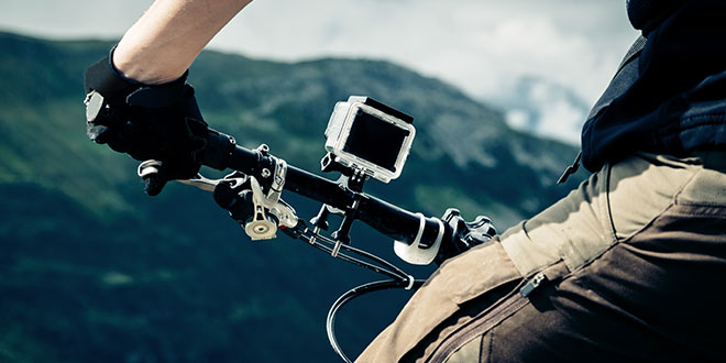 A dash camera mounted on the handlebar of a mountain bike