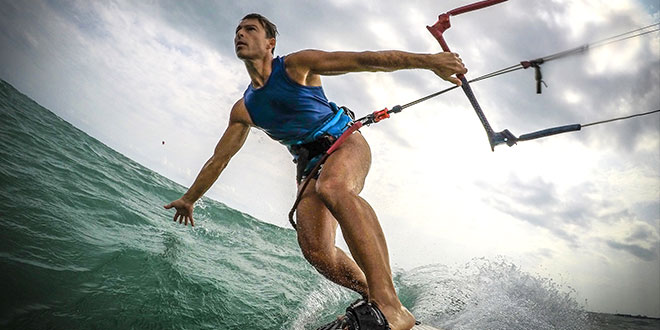 A camera recording a wind surfer gliding through waves